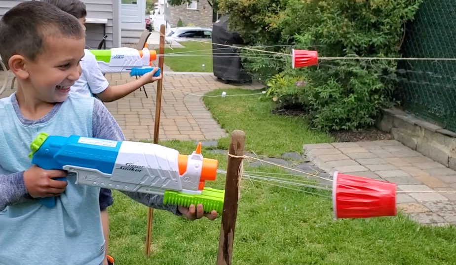super soaker water blaster races begin with two friends
